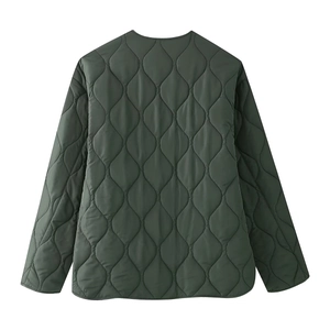 Detail view of the quilted texture and stitching on this dark green zip-up jacket