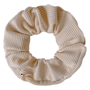 Close-up of beige ribbed velvet hair scrunchie with soft elastic fabric texture