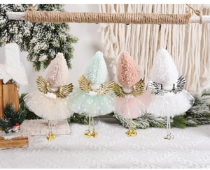 Plush angel ornaments with mesh skirts and metal wings on a festive Christmas tree