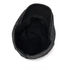 Internal view of wool newsboy cap showing black fabric lining and sweatband detail