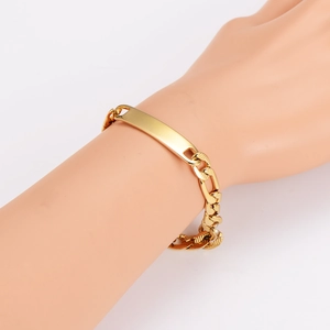Gold stainless steel Figaro ID bracelet with curved polished plate on model's wrist