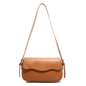 Brown leather shoulder bag with minimalist flap design and adjustable strap on white background