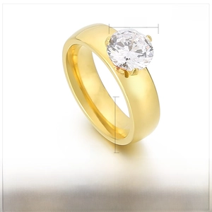 Macro detail of 8mm round zircon stone on 6mm wide gold stainless steel ring