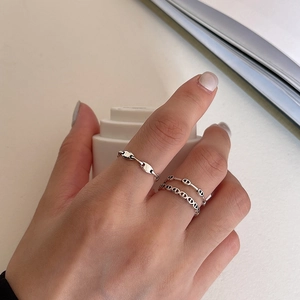 Detail shot of two minimalist 925 silver rings including a classic pig nose chain style