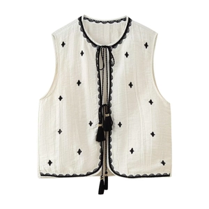 Women's cream vest and shorts set featuring black diamond embroidery and tassel ties