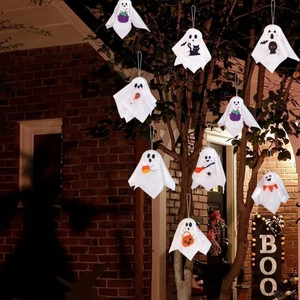 Ghost hanging decorations with pumpkin and cat patterns on trees for Halloween atmosphere