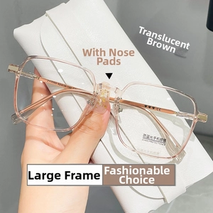Detail view of tea-colored polygonal frames with nose pads and blue light filter lenses