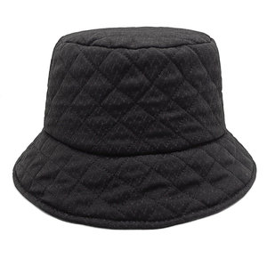 Close-up of black quilted bucket hat featuring classic diamond stitching and thermal fabric