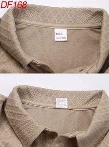 Detail of the diamond waffle knit texture and L size label on a khaki polo shirt