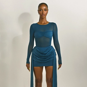 Detail of navy blue bodycon dress with sheer mesh panel and pleated draping fabric