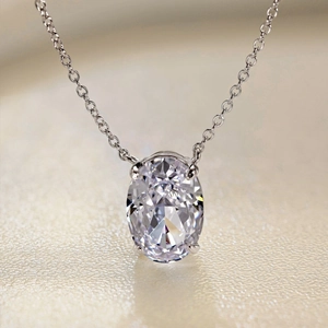 Macro shot of oval cut pendant showing 4-prong setting and fine S925 silver chain