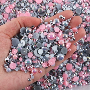 Macro detail of mixed color flatback pearls and resin rhinestones for nail art DIY