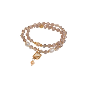 Elegant double-layered bracelet with pink cat eye stones, pearls, and planet charm