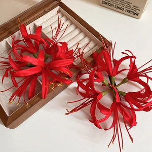 Detailed close-up of handmade red lycoris flower hair clips with delicate silk petals