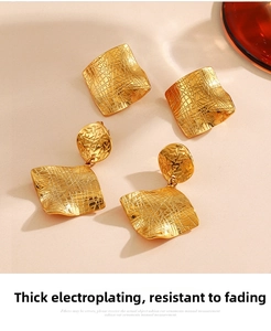 Detailed view of 18K gold geometric earrings featuring unique hammered metal texture