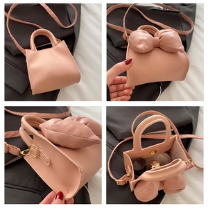 Detailed views of a pink mini bucket bag featuring a cute oversized bow and crossbody strap