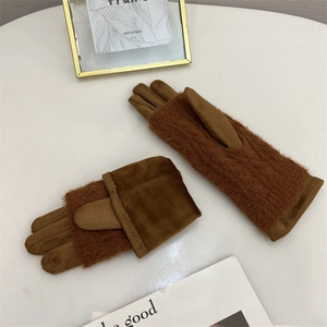 Detailed macro view of brown plush suede gloves with warm fleece lining and knit cuffs