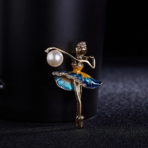 Detail of ballet dancer brooch with teal enamel dress, rhinestones and a white pearl