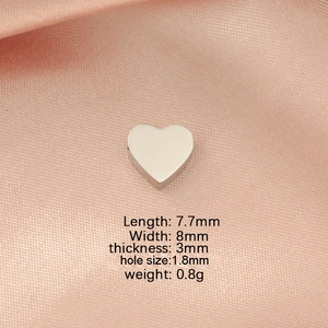 Polished heart charm measurements: 7.7x8mm with 1.8mm hole on pink satin fabric