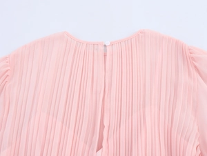 Detailed view of pink chiffon pleated dress back neckline with round button closure