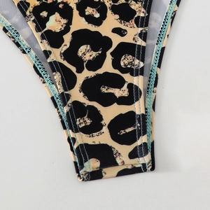 Detail of leopard print bikini bottom with vibrant blue contrast stitching and clean seams