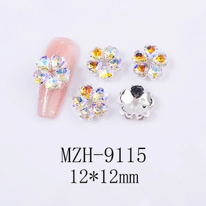 Detail of 12x12mm hollow star and flower nail rhinestones on pink matte false nail tips