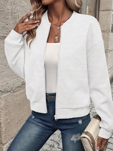 Outdoor street style view of white quilted texture baseball jacket with zipper closure