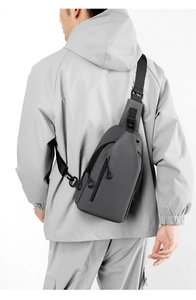 Macro shot of grey waterproof fabric texture and adjustable black strap on the chest bag