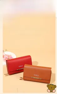 Detail of colorful long leather phone wallets with gold metal trim and zipper closure