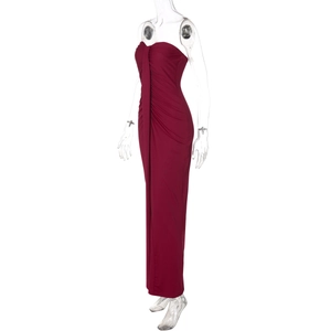 Detailed view of burgundy strapless dress with ruched bodice and draped fabric on mannequin