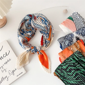 Pleated silk scarf with paisley and zebra patterns on a clean white background