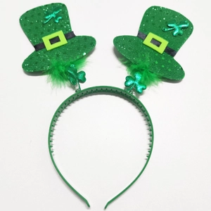 Detail of green St. Patrick's Day headband with sparkling mini hats and feathers