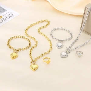 Detail of gold and silver jewelry sets featuring heart pendants and OT toggle clasps