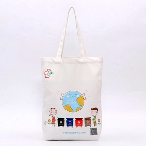 Detail of eco-friendly white canvas tote with recycling bins and earth illustrations