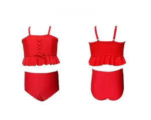 Flat lay of red girls' two-piece swimsuit with ruffle trim and lace-up front detail