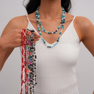 Close-up of bohemian multi-layered beaded necklaces with sea shells and colorful crystals