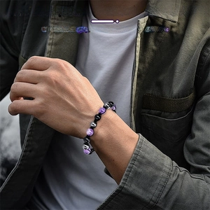 Detail of 8mm amethyst and obsidian beads triple protection bracelet on a male wrist