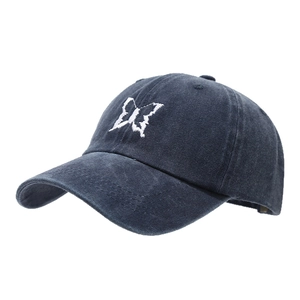 Navy blue washed cotton baseball cap with white butterfly embroidery in 45-degree view