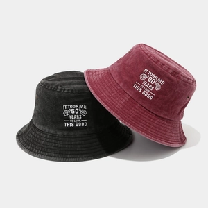 Washed cotton bucket hats in black and burgundy with vintage birthday embroidery