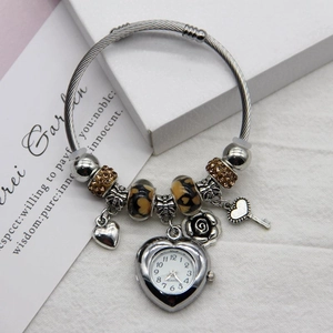 Detail of silver beaded bracelet with heart watch pendant and rose flower charms