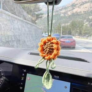 Handmade crochet sunflower car hanging ornament with orange petals and green leaves