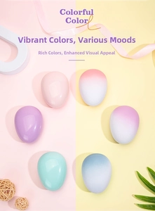 Group of colorful egg-shaped detangling hair brushes in matte gradient pastel colors