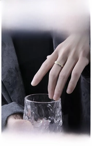 Close-up of black and gold business ring with textured patterns on a male model