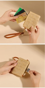 Detail of straw woven coin purse with brown wrist strap, showing card slots and coins