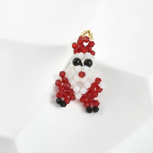 Macro view of a handmade beaded Santa Claus charm with red, white, and gold faceted beads