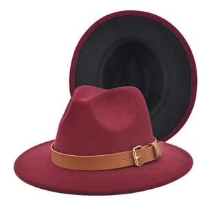 Detail of burgundy fedora hat with camel leather band and contrast black brim interior