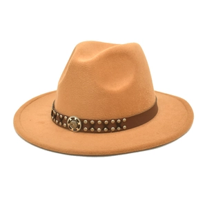 Detail of camel fedora hat with brown leather band and silver metal buckle decoration