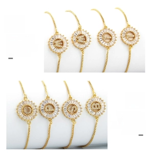 Detail of adjustable gold-plated chain bracelet with circular micro-pave zircon letter charm