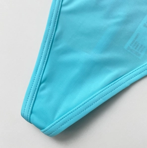 Macro view of sky blue water-soluble lace fabric with precision double-stitch seams