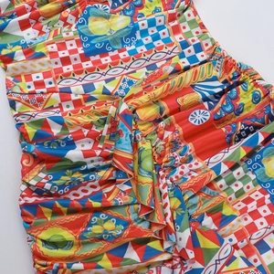 Detail showing colorful lemon and geometric print with ruched fabric texture on dress